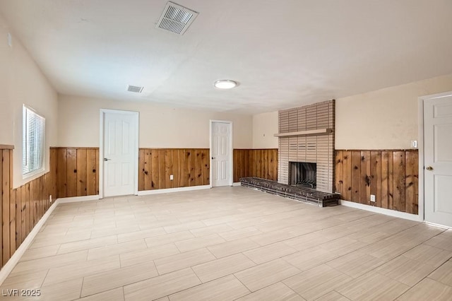1404 Atlantic St, Las Vegas, NV 89104 - unfurnished living room featuring a wainscoted wall, wood walls, and a brick fireplace