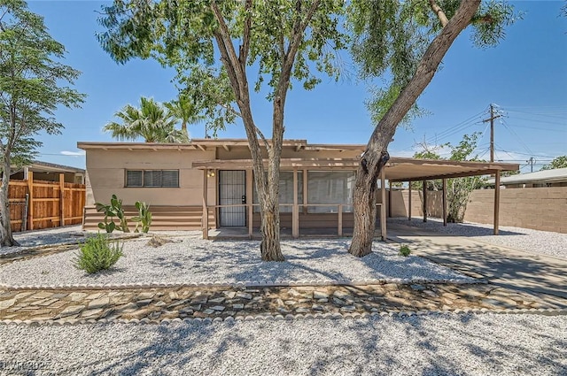 1404 Atlantic St, Las Vegas, NV 89104 - view of front of property with a sunroom, stucco siding, and a patio area