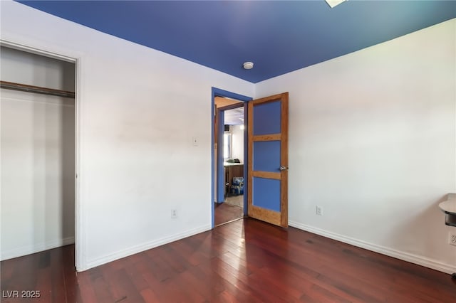 300 N 14th St, Las Vegas, NV 89101 - unfurnished bedroom featuring wood finished floors, baseboards, and a closet