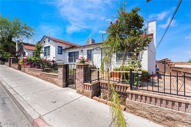 300 N 14th St, Las Vegas, NV 89101 - view of front of house with a chimney, a fenced front yard, and a gate
