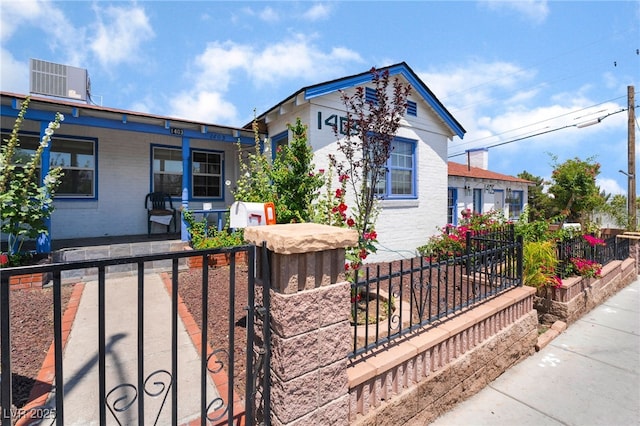 300 N 14th St, Las Vegas, NV 89101 - view of front facade with covered porch, a fenced front yard, central air condition unit, brick siding, and a gate