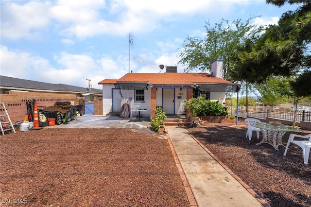 300 N 14th St, Las Vegas, NV 89101 - rear view of property featuring a chimney, brick siding, covered porch, and a patio