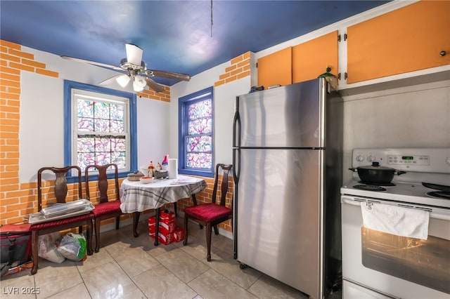 300 N 14th St, Las Vegas, NV 89101 - kitchen with electric range, freestanding refrigerator, a ceiling fan, and light tile patterned floors
