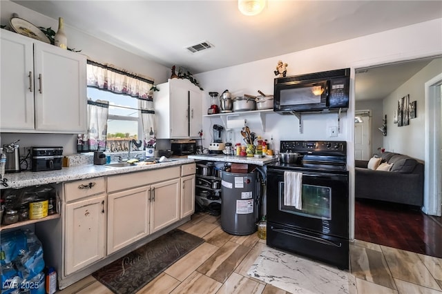300 N 14th St, Las Vegas, NV 89101 - kitchen featuring black appliances, light countertops, open shelves, wood finish floors, and a sink