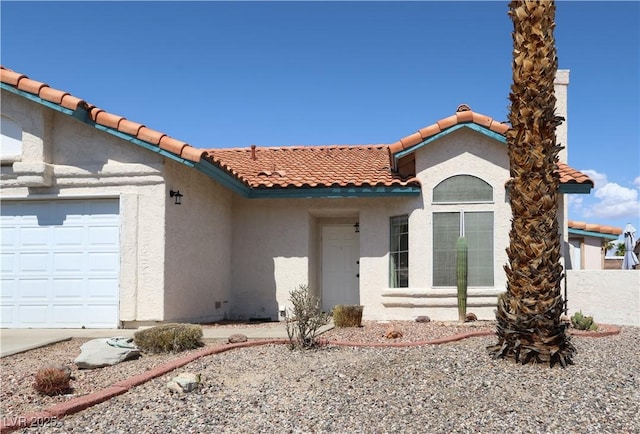 3236 Manzanita Ln, Laughlin, NV 89029 - view of front of home with stucco siding, a tiled roof, and a garage