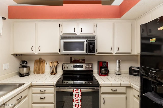3236 Manzanita Ln, Laughlin, NV 89029 - kitchen with stainless steel appliances, white cabinets, and a sink