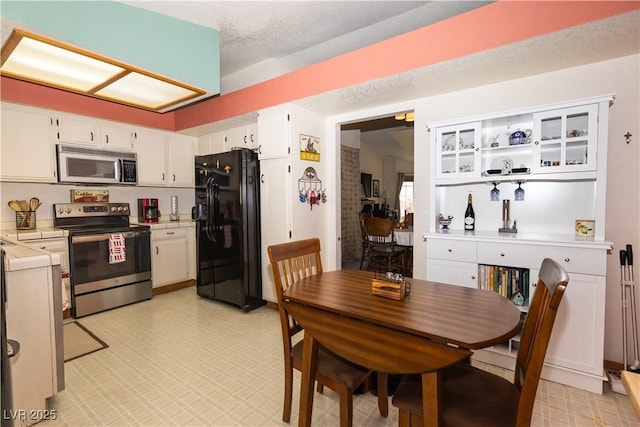 3236 Manzanita Ln, Laughlin, NV 89029 - dining space with a dry bar and light floors