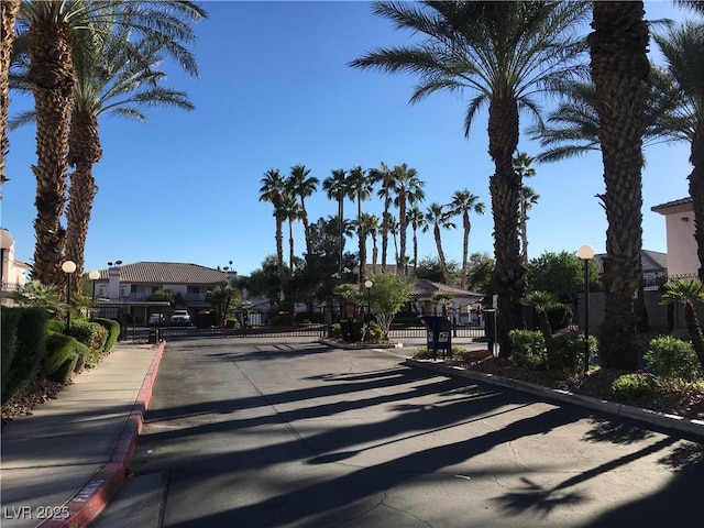 4555 E Sahara Ave Unit 226, Las Vegas, NV 89104 - view of asphalt road featuring a gate, curbs, a gated entry, and sidewalks