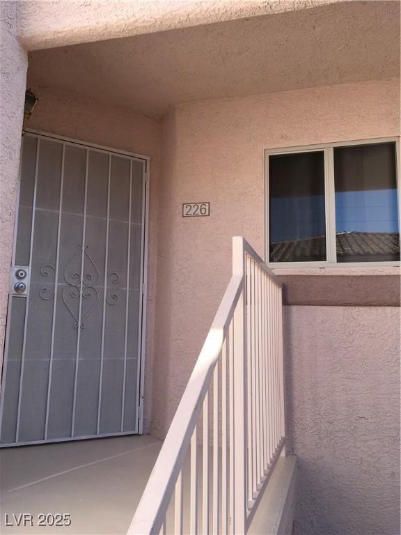 4555 E Sahara Ave Unit 226, Las Vegas, NV 89104 - doorway to property featuring stucco siding and a balcony