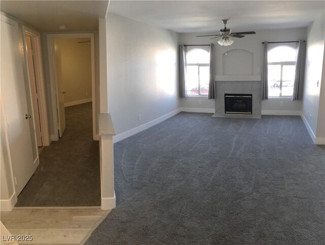 4555 E Sahara Ave Unit 226, Las Vegas, NV 89104 - unfurnished living room featuring ceiling fan, carpet floors, and a premium fireplace