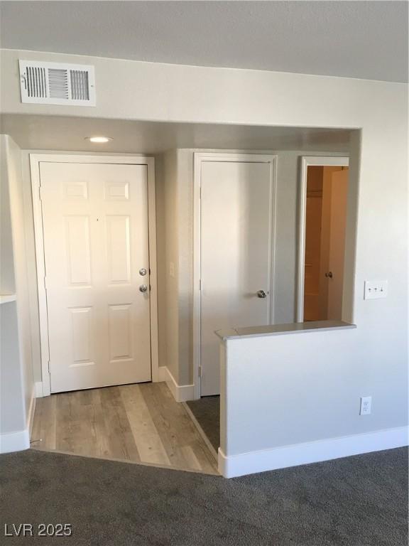 4555 E Sahara Ave Unit 226, Las Vegas, NV 89104 - foyer entrance featuring baseboards, light colored carpet, and light wood-style flooring