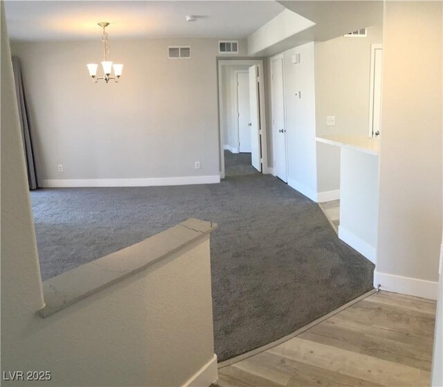 4555 E Sahara Ave Unit 226, Las Vegas, NV 89104 - carpeted spare room featuring a chandelier and baseboards