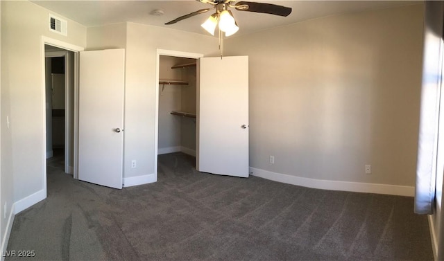 4555 E Sahara Ave Unit 226, Las Vegas, NV 89104 - unfurnished bedroom with dark carpet, baseboards, a walk in closet, a closet, and ceiling fan