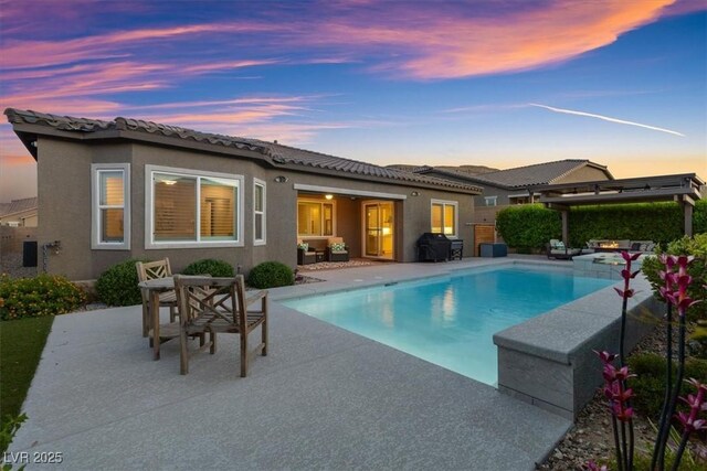 6192 Lautman Ridge Ct, Las Vegas, NV 89141 - back of house at dusk featuring stucco siding, an outdoor living space, an outdoor pool, a patio area, and a pergola