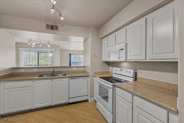 8000 Badura Ave Unit 2028, Las Vegas, NV 89113 - kitchen featuring white appliances, a sink, track lighting, and white cabinetry