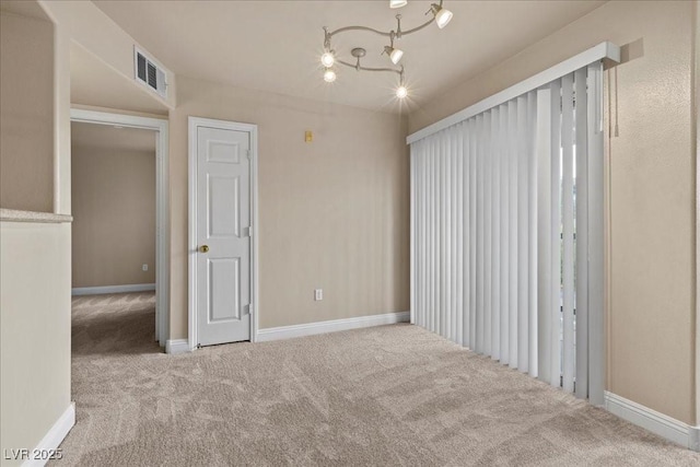 8000 Badura Ave Unit 2028, Las Vegas, NV 89113 - empty room featuring carpet flooring, baseboards, and a chandelier