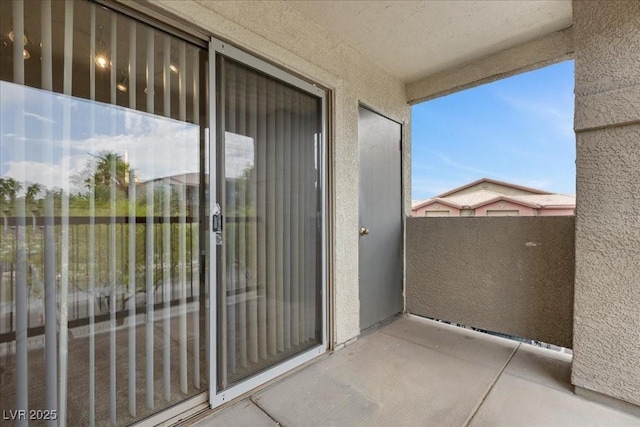 8000 Badura Ave Unit 2028, Las Vegas, NV 89113 - property entrance with a balcony and stucco siding