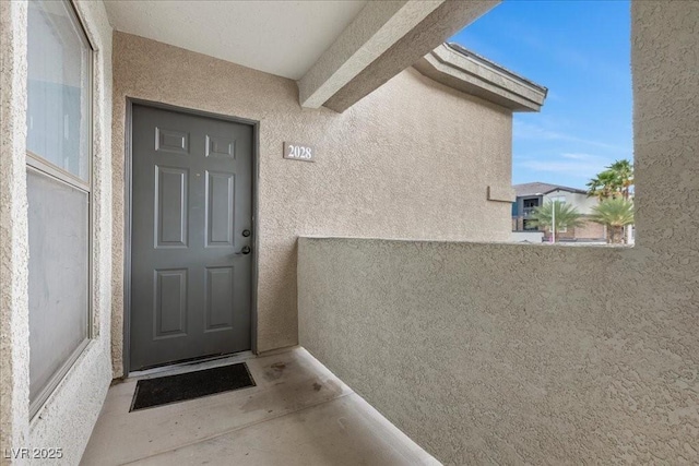 8000 Badura Ave Unit 2028, Las Vegas, NV 89113 - doorway to property with stucco siding and a balcony
