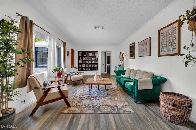 4419 Lorna Pl, Las Vegas, NV 89107 - living area featuring a textured ceiling, wood finished floors, ornamental molding, and built in features