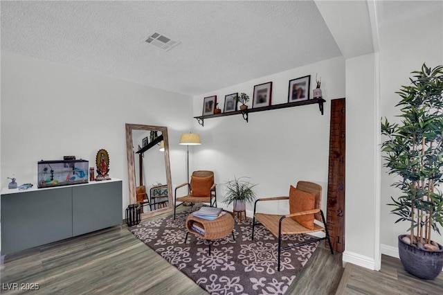 4419 Lorna Pl, Las Vegas, NV 89107 - sitting room featuring wood finished floors, a textured ceiling, and baseboards