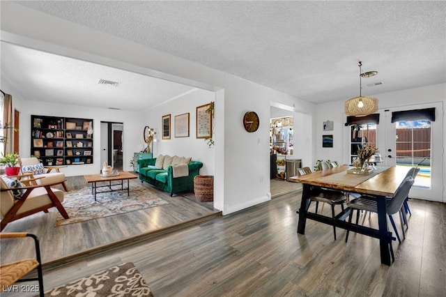 4419 Lorna Pl, Las Vegas, NV 89107 - dining area with a textured ceiling, wood finished floors, baseboards, and french doors