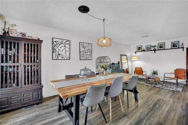 4419 Lorna Pl, Las Vegas, NV 89107 - dining room with a textured ceiling and wood finished floors