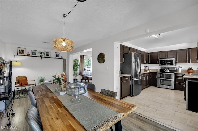 4419 Lorna Pl, Las Vegas, NV 89107 - dining area featuring light wood-style floors and a textured ceiling