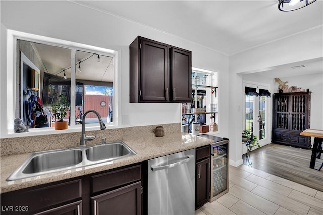 4419 Lorna Pl, Las Vegas, NV 89107 - kitchen with dishwasher, a sink, dark brown cabinetry, beverage cooler, and french doors