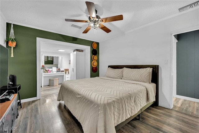4419 Lorna Pl, Las Vegas, NV 89107 - bedroom featuring ornamental molding, wood finished floors, baseboards, ceiling fan, and a textured ceiling