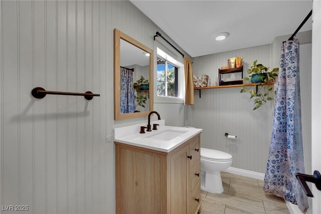 4419 Lorna Pl, Las Vegas, NV 89107 - full bath featuring vanity, toilet, curtained shower, and wood walls