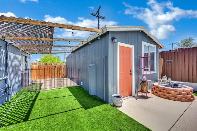 4419 Lorna Pl, Las Vegas, NV 89107 - view of outbuilding with a fenced backyard and a fire pit