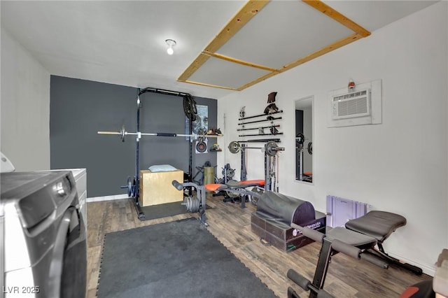 4419 Lorna Pl, Las Vegas, NV 89107 - exercise area featuring washer and dryer, wood finished floors, and a wall unit AC