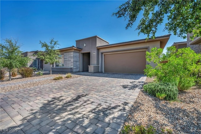6684 Regency Stone Way, Las Vegas, NV 89148 - view of front of property with decorative driveway, a garage, and stucco siding