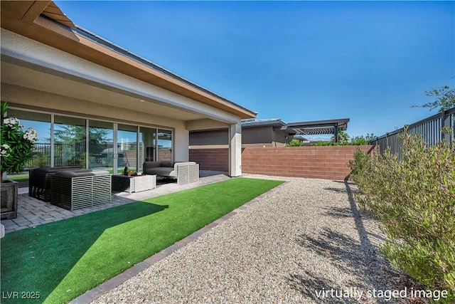 6684 Regency Stone Way, Las Vegas, NV 89148 - fenced backyard with an outdoor living space and a patio area