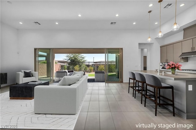 6684 Regency Stone Way, Las Vegas, NV 89148 - living area featuring plenty of natural light, recessed lighting, a high ceiling, and light tile patterned floors