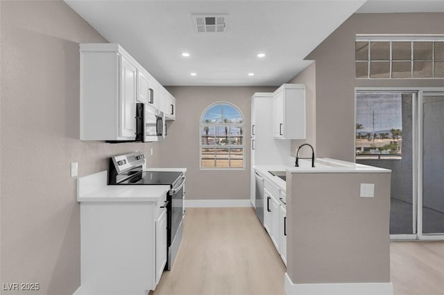3150 Soft Breezes Dr Unit 2186, Las Vegas, NV 89128 - kitchen featuring appliances with stainless steel finishes, light wood-type flooring, a sink, white cabinets, and recessed lighting