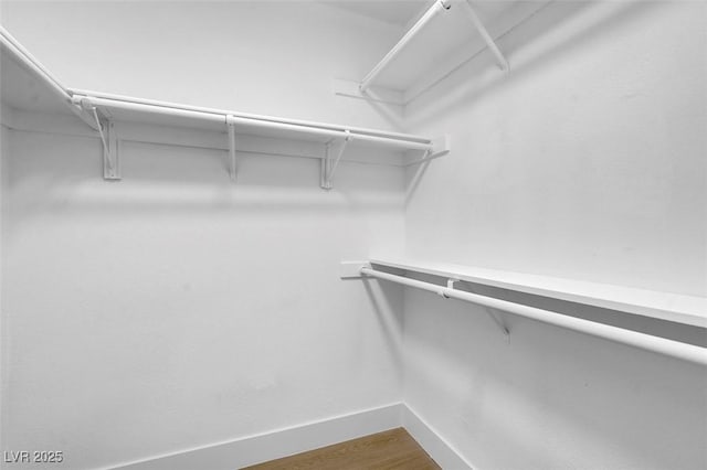 3150 Soft Breezes Dr Unit 2186, Las Vegas, NV 89128 - walk in closet featuring dark wood-type flooring