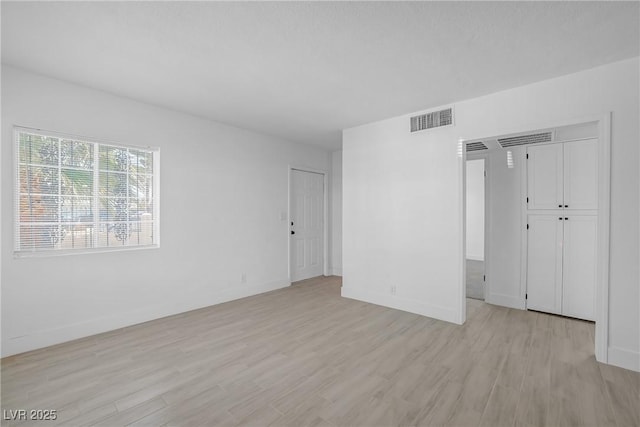 1608 E Mcdonald Ave, North Las Vegas, NV 89030 - unfurnished room with light wood-style floors and baseboards