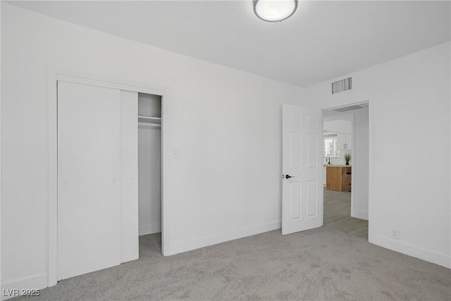 1608 E Mcdonald Ave, North Las Vegas, NV 89030 - unfurnished bedroom featuring carpet flooring, a closet, and baseboards