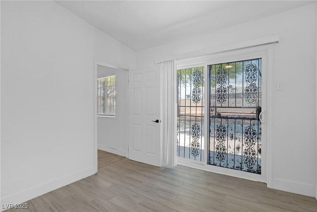 1608 E Mcdonald Ave, North Las Vegas, NV 89030 - empty room with wood finished floors, healthy amount of natural light, and baseboards