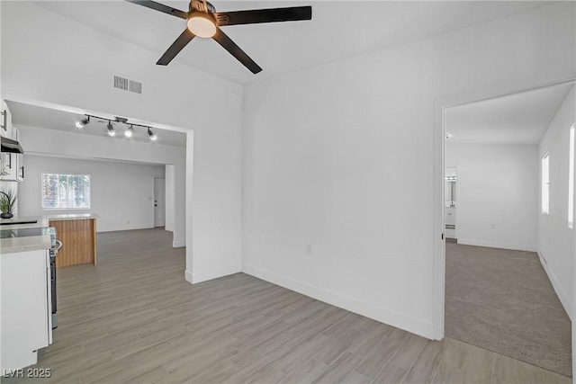 1608 E Mcdonald Ave, North Las Vegas, NV 89030 - unfurnished living room featuring ceiling fan, light wood finished floors, and baseboards