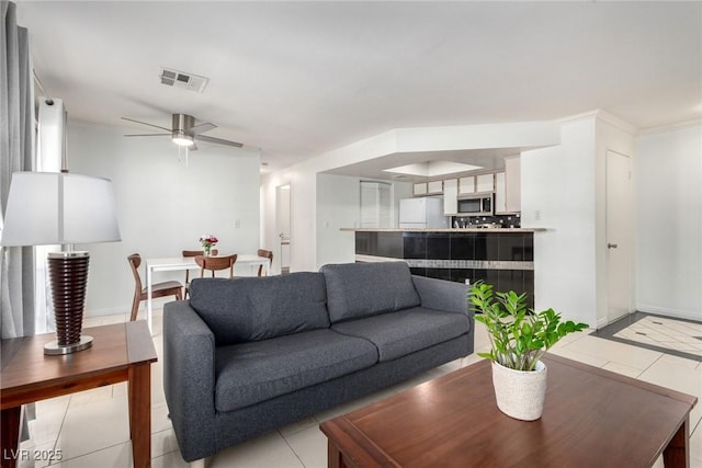 8600 W Charleston Blvd Unit 2085, Las Vegas, NV 89117 - living area featuring light tile patterned floors, a ceiling fan, and baseboards