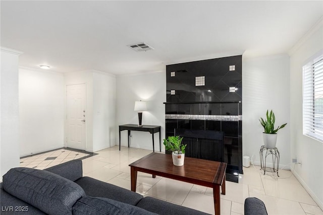 8600 W Charleston Blvd Unit 2085, Las Vegas, NV 89117 - living room featuring crown molding, baseboards, a tiled fireplace, and marble look tiles
