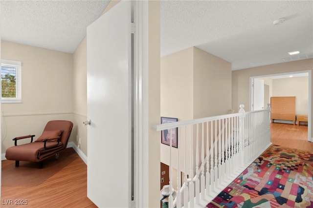 6612 Elton Ave, Las Vegas, NV 89107 - hallway with light wood-style floors, a textured ceiling, and baseboards