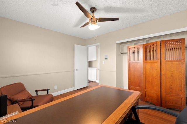 6612 Elton Ave, Las Vegas, NV 89107 - home office featuring a ceiling fan, wood finished floors, baseboards, and a textured ceiling