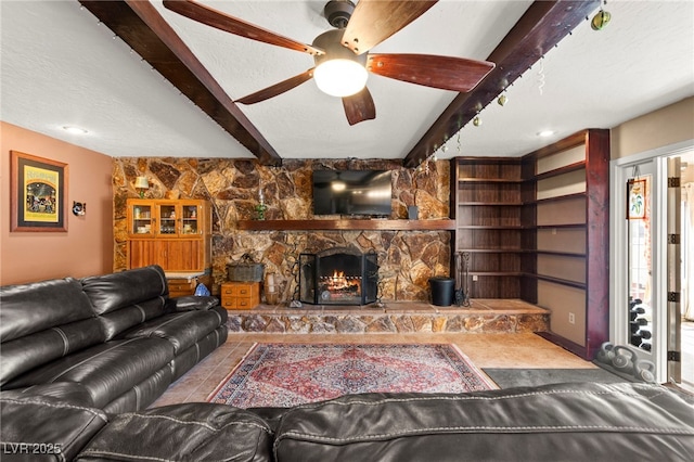 6612 Elton Ave, Las Vegas, NV 89107 - living room with beamed ceiling, a stone fireplace, and ceiling fan