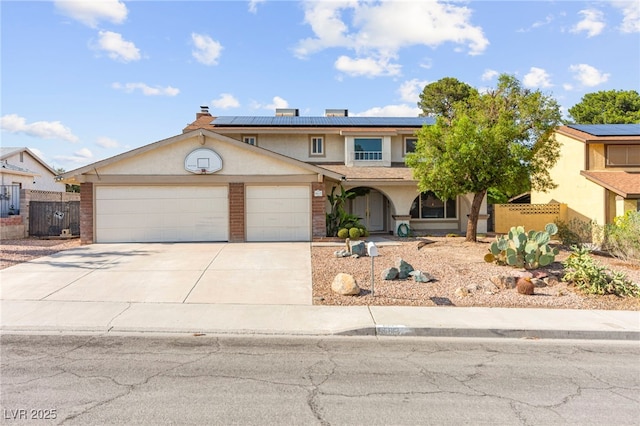 6612 Elton Ave, Las Vegas, NV 89107 - view of front of property with solar panels, concrete driveway, an attached garage, stucco siding, and brick siding