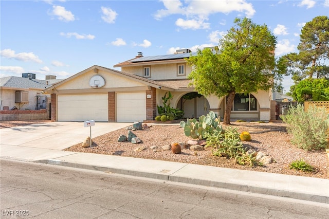 6612 Elton Ave, Las Vegas, NV 89107 - view of front of property with an attached garage, solar panels, driveway, and stucco siding