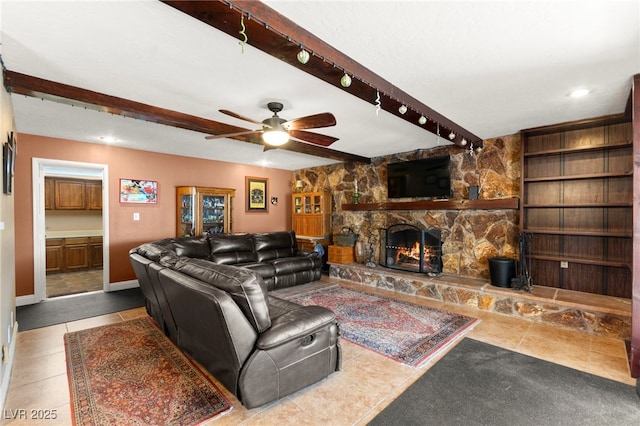6612 Elton Ave, Las Vegas, NV 89107 - living area with beam ceiling, a fireplace, a ceiling fan, and baseboards
