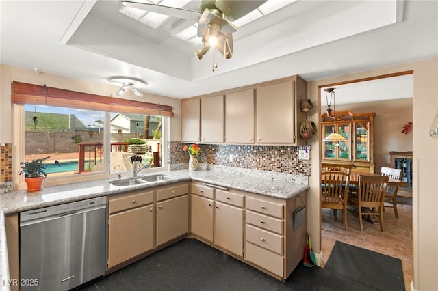 6612 Elton Ave, Las Vegas, NV 89107 - kitchen featuring stainless steel dishwasher, a sink, a raised ceiling, and cream cabinetry